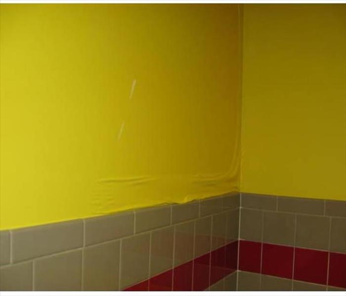 yellow bathroom wall with water damage 