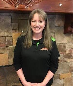 Woman Smiling in Black SERVPRO polo shirt 