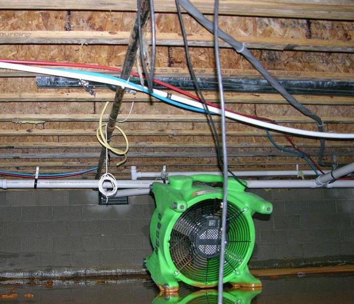 muddy water in crawl space with fan in it to dry it out 