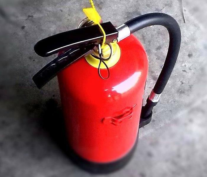 Fire extinguisher on concrete floor 